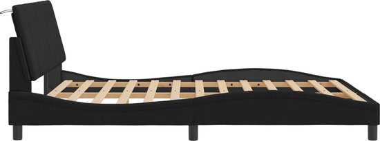 Vue de côté d'un cadre de lit noir avec sommier à lattes et tête de lit réglable.