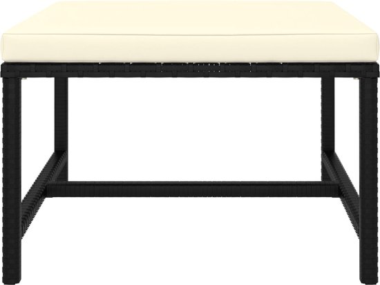 Table basse rectangulaire noire avec coussin crème.