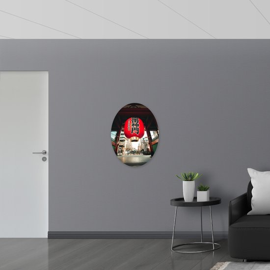 PVC Schuimplaat Ovaal - Mega Rode Lampion met Chinese Tekens in Grote Stad - 60x80 cm Foto op Ovaal (Met Ophangsysteem)
