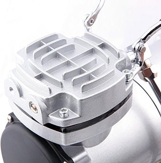 Detailopname van de zilverkleurige, geribbelde bovenkant van de airbrush compressor.