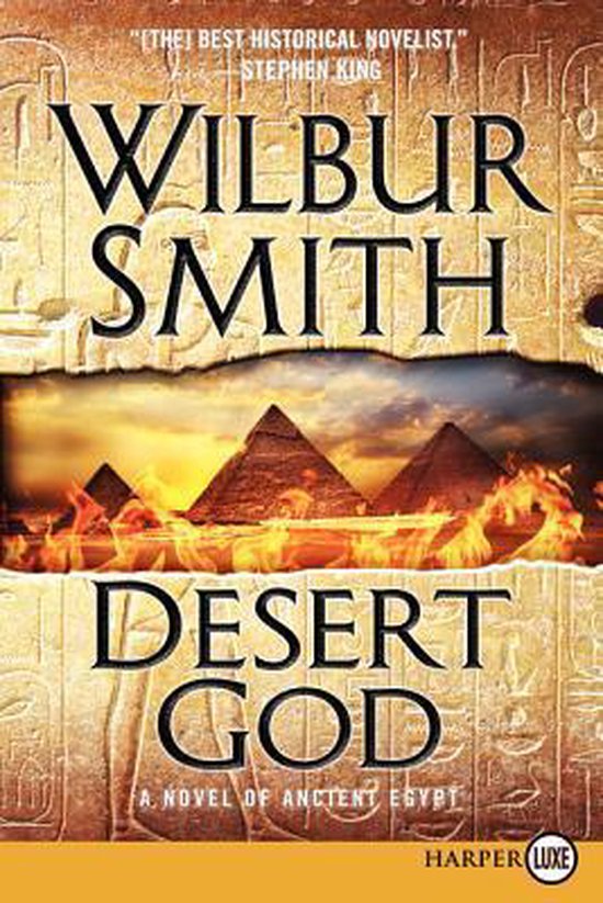 Boekomslag 'Desert God' van Wilbur Smith. Piramides bij zonsondergang met vlammen.