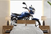 Behang - Fotobehang Close-up van een blauwe motorfiets - Breedte 220 cm x hoogte 220 cm