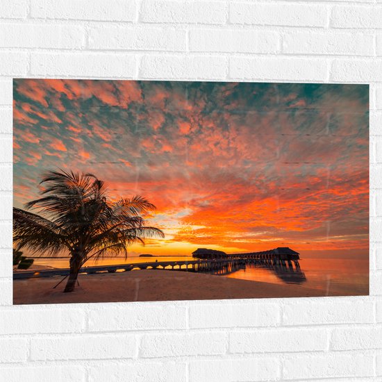 Muursticker - Zonsondergang op het Strand met Palmbomen en Paalwoningen - 90x60 cm Foto op Muursticker
