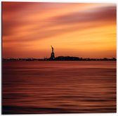 WallClassics - Dibond - Vrijheidsbeeld in New York van Ver met Zonsondergang - 50x50 cm Foto op Aluminium (Wanddecoratie van metaal)