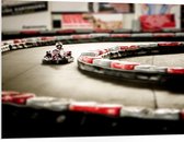 WallClassics - PVC Schuimplaat - Karter op Indoor Kartbaan - 100x75 cm Foto op PVC Schuimplaat (Met Ophangsysteem)