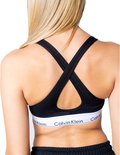 Zwarte Calvin Klein bralette met gekruiste bandjes op de rug en witte tailleband met logo.