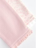 Een roze gestreepte legging en een met bloemenprint. Ruches aan de onderkant.