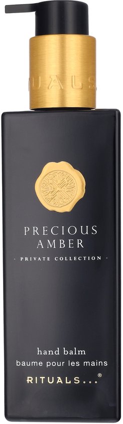 Zwarte fles met gouden pompdispenser voor "PRECIOUS AMBER PRIVATE COLLECTION hand balm".