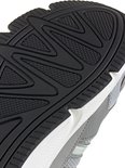 Detail van zwarte rubberen buitenzool met visgraatmotief van grijze Adidas sneaker.