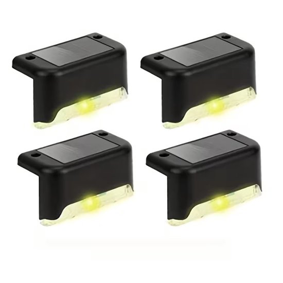 Quatre lampes solaires LED noires en forme de L avec une lumière blanche.