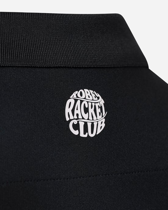Close-up van de kraag van een zwarte poloshirt met het witte 'Racket Club' logo.