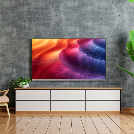 Een grote, randloze televisie met een levendige, abstracte kleurenafbeelding van oranje, roze en blauwe golven.
