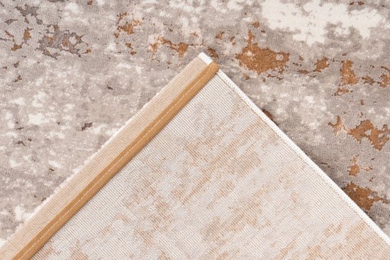 Onderkant van het beige-bruine vloerkleed met een geweven structuur en een beige bies.
