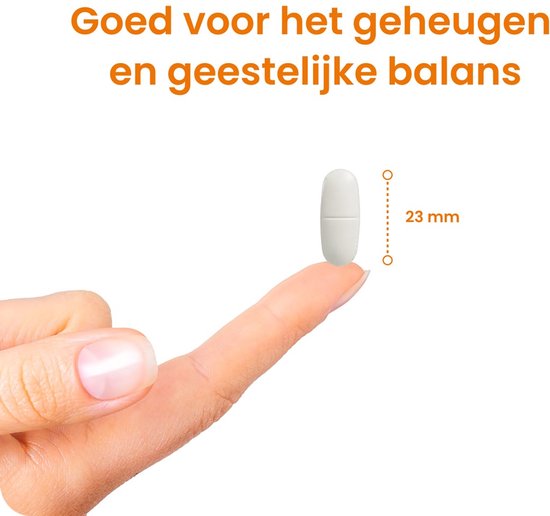 Witte tablet met deelstreep, 23 mm lang, op een vingertop