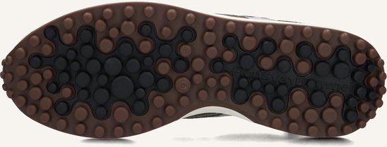 Onderkant van de sneaker met ronde bruine noppen en Floris van Bommel logo.
