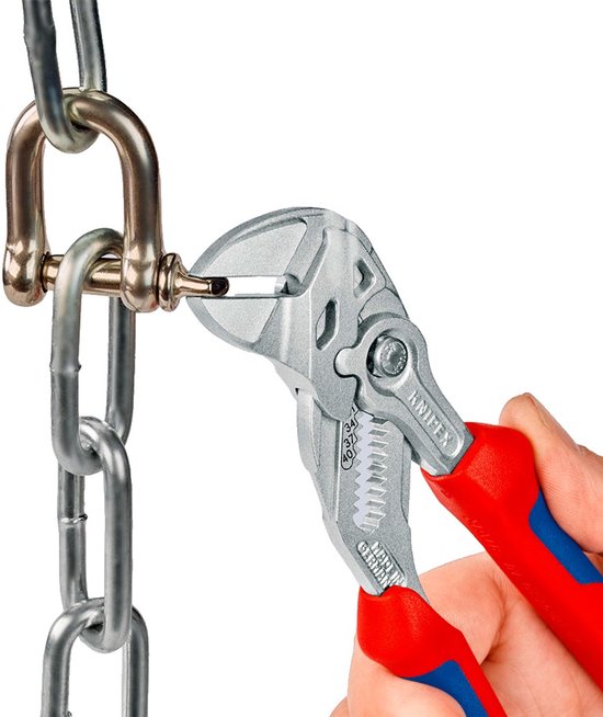 Hand houdt een Knipex tang met rood-blauwe handvatten vast om een metalen ketting te manipuleren.