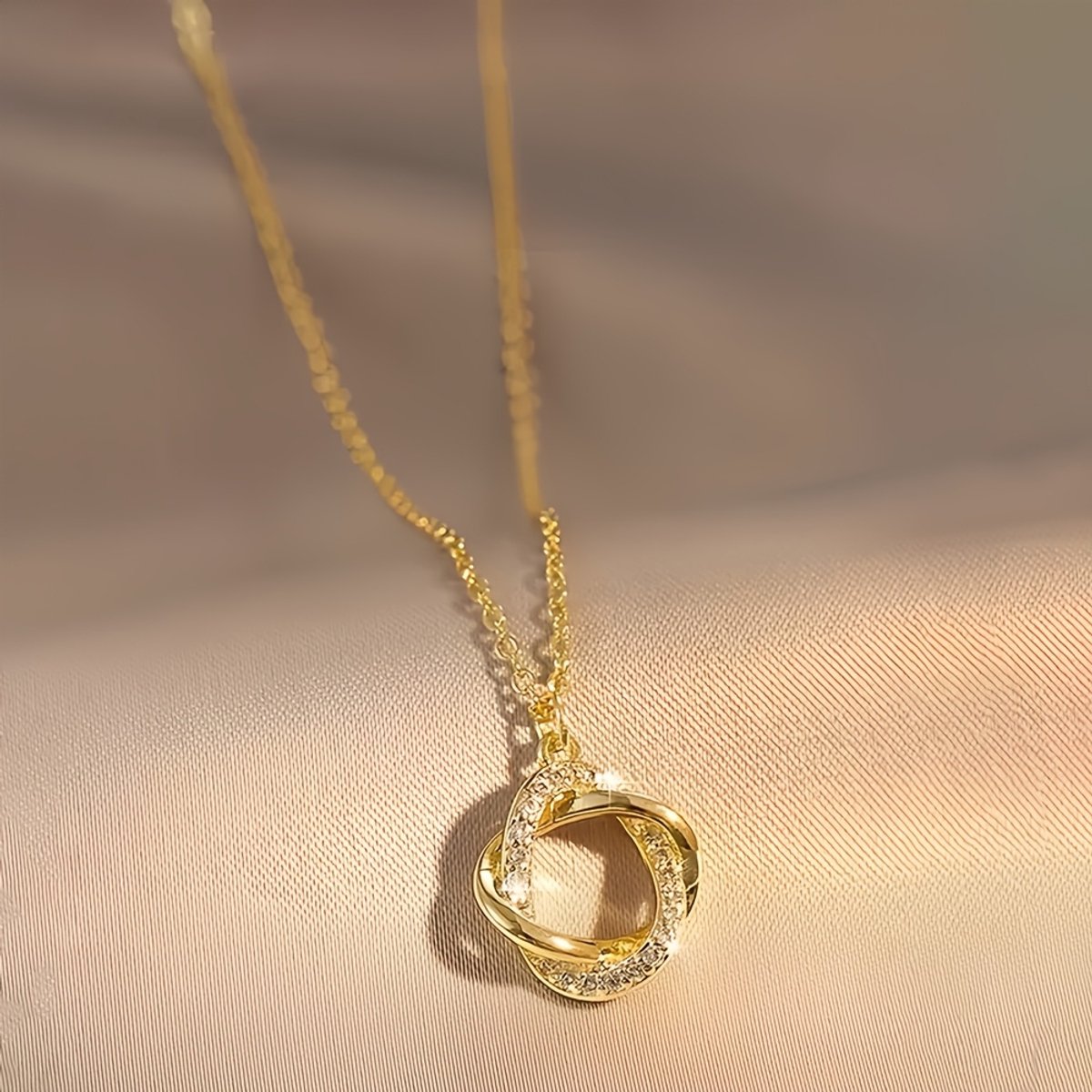 Sjika - Gold plated ketting met verstrengelde cirkel hanger – Luxe damesketting met zirkonia – Tijdloos & elegant design – Perfect cadeau voor haar
