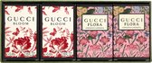 Verpakking met vier Gucci mini-parfums. Twee met rode bloemen en vlinders, twee met roze bloemen.