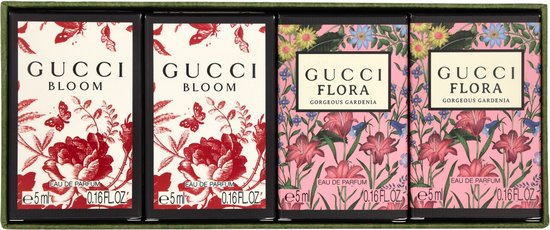 Verpakking met vier Gucci mini-parfums. Twee met rode bloemen en vlinders, twee met roze bloemen.