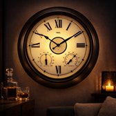 Een verlichte, bronzen wandklok met Romeinse cijfers, thermometer en hygrometer hangt in een sfeervolle kamer.