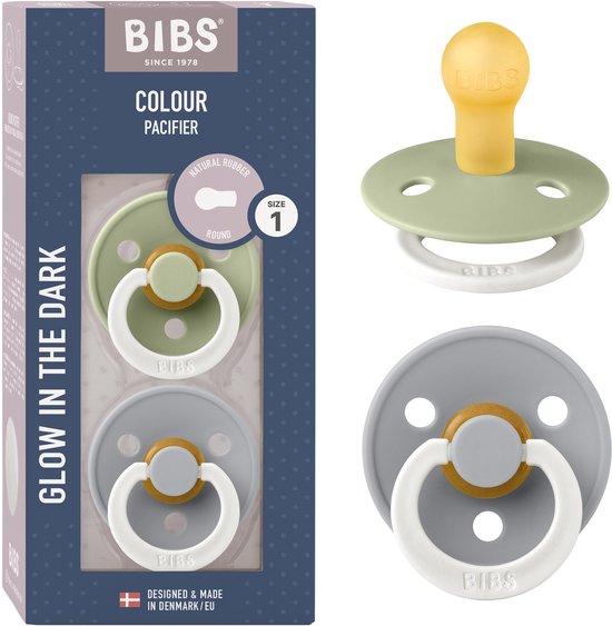 Verpakking met twee BIBS Colour Glow fopspenen: een lichtgroene en een grijze, met gele speentjes.