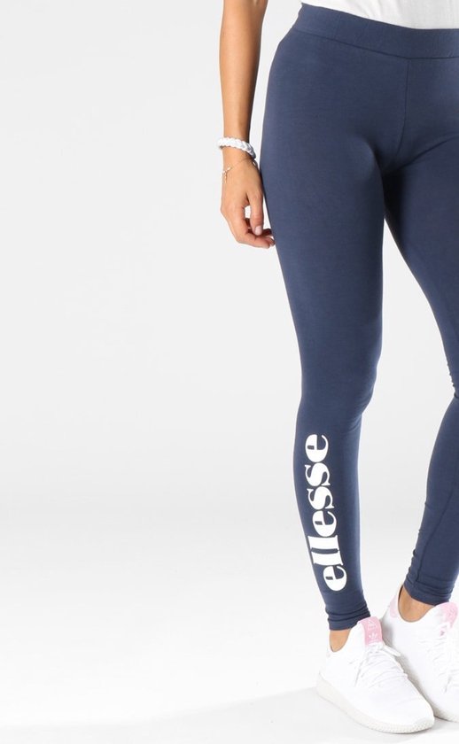 Marineblauwe Ellesse legging met wit logo op de zijkant, gedragen door een model.