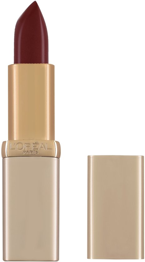 Gouden huls met een diep bordeauxrode lipstick punt. De zilveren dop ligt ernaast.