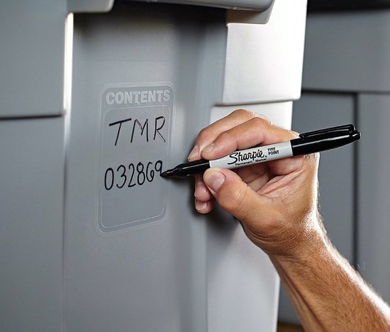 Een hand met een zwarte Sharpie marker schrijft "CONTENTS TMR 032869" op een grijze opbergbak.