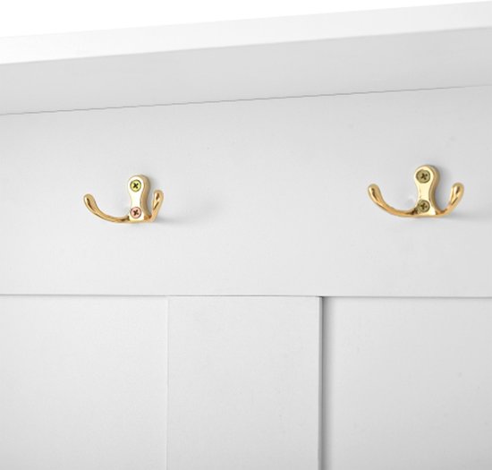 Twee gouden haken aan de muur van een witte kapstok.