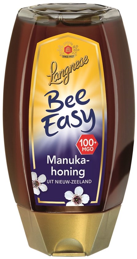 Langnese Bee Easy Manuka honing in een fles met gouden dop en label met "Bee Easy", 100+ MGO, en witte bloemen.
