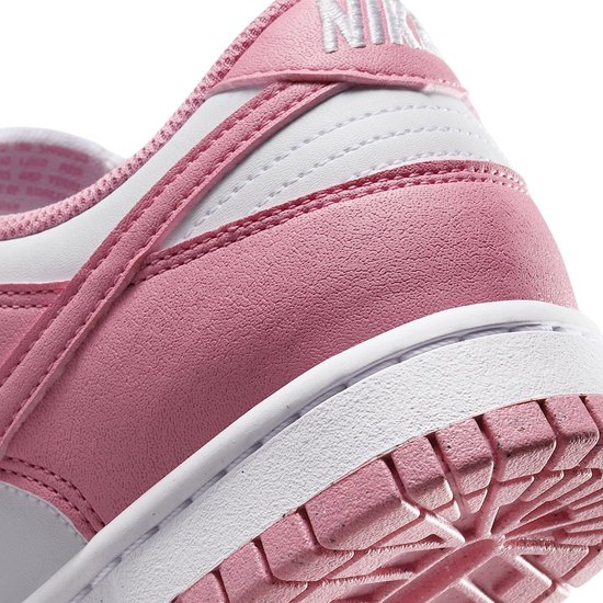 Detail van roze en witte Nike Dunk Low sneaker, hak met Nike logo.