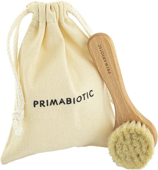 Brosse visage en bois à poils de chèvre doux et pochette en tissu beige avec logo "Primabiotic"