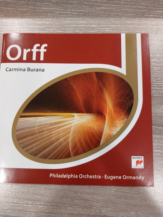 Voorkant cd-hoesje Carmina Burana van Orff, met abstracte oranje-gouden lijnen in een ovaal en witte tekst op rood.