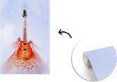 Behang - Fotobehang Een elektrische gitaar in de lucht - Breedte 150 cm x hoogte 220 cm