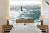 Behang - Fotobehang De vuurtoren van la Jument in de zee voor de Franse kust - Breedte 260 cm x hoogte 260 cm