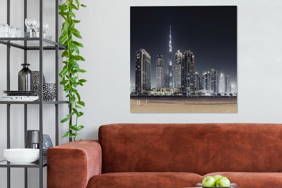 Canvas schilderij 90x90 cm - Wanddecoratie De Burj Khalifa verlicht met andere wolkenkrabbers de lucht boven Dubai - Muurdecoratie woonkamer - Slaapkamer decoratie - Kamer accessoires - Schilderijen op canvas