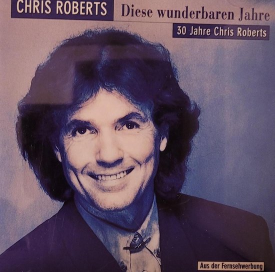 Portret van Chris Roberts met een glimlach en donker, warrig haar.