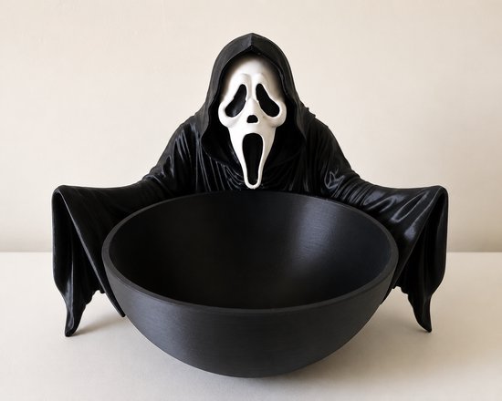 Un distributeur de bonbons effrayant en forme de Ghostface avec un bol large et noir.