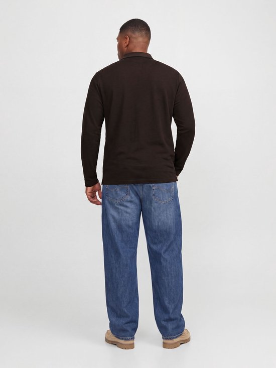 Achteraanzicht van een model in een bruine polo met lange mouwen, blauwe jeans en beige schoenen.