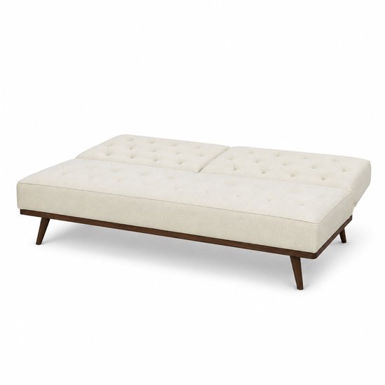 Crème witte 2-zits slaapbank uitgeklapt als bed, met donkerhouten poten.