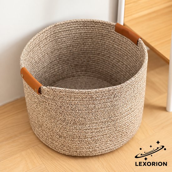 Gedetailleerde bovenkant van een ronde beige gevlochten opbergmand met bruine leren handvatten, merk Lexorion.