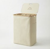 Crèmekleurige wasmand met bamboe rand en deksel, met drie interne vakken en een zijvak.