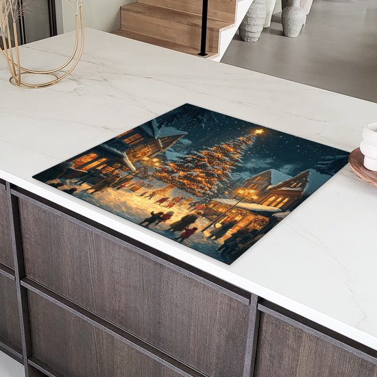Inductiebeschermer met kerstdorp-print op een kookplaat in een moderne keuken.