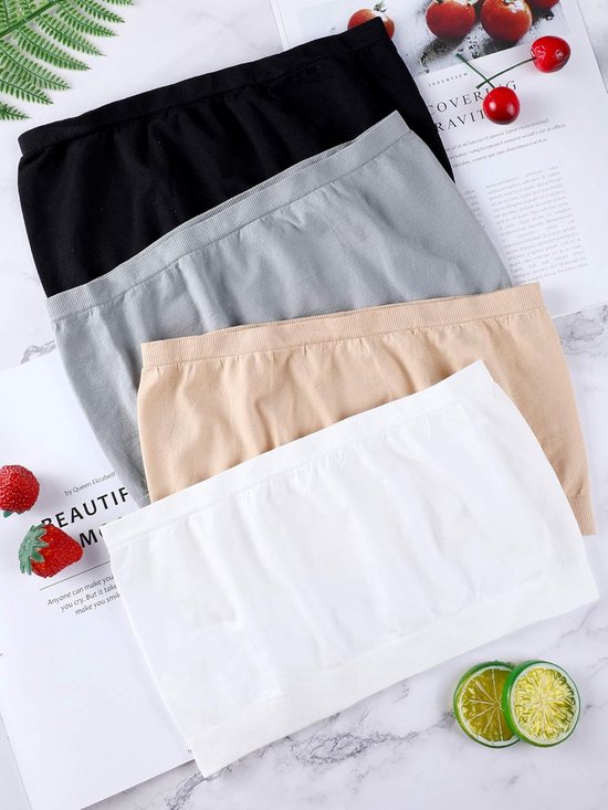 Zwarte, grijze, beige en witte strapless bandeau bh's opgestapeld.