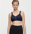 Zwarte sportbeha met een blauw paneel en een gestippelde print, gedragen door een model.