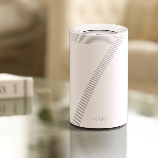 Witte Deco BE65 router met grijze lijnen en 'deco' logo, staand op een glazen tafel.