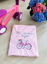 Personalized pink baby blanket with a bicycle and dedication embroidered