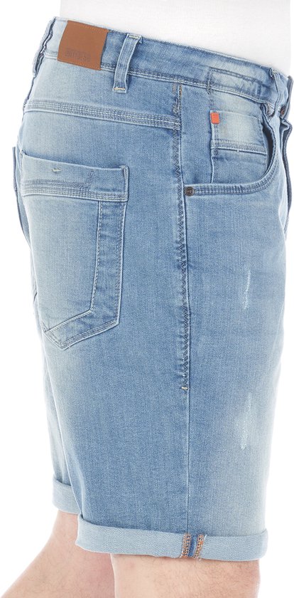 Zijkant van een lichtblauwe denim short met omgeslagen broekspijpen, slijtageplekken en oranje details.