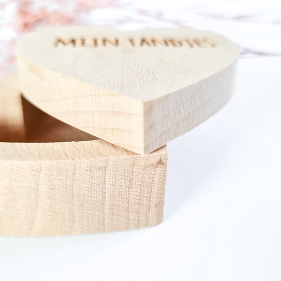 Close-up van een houten hartvormig doosje, open, met tekst "MIJN TANDJES".