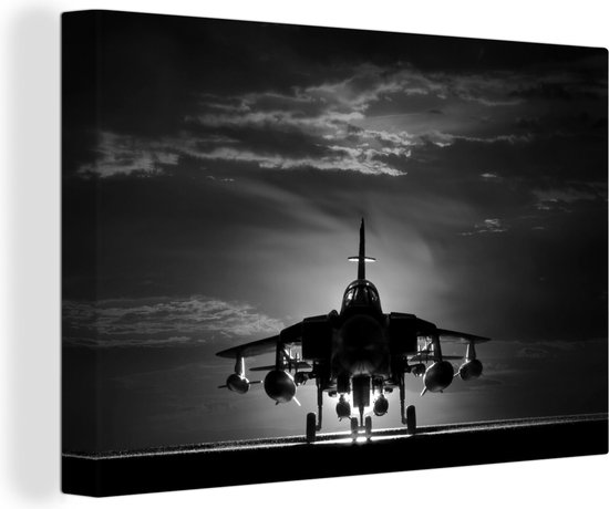 Tableau sur toile Une silhouette d'un avion de chasse lors d'un coucher de  soleil -... | bol.com